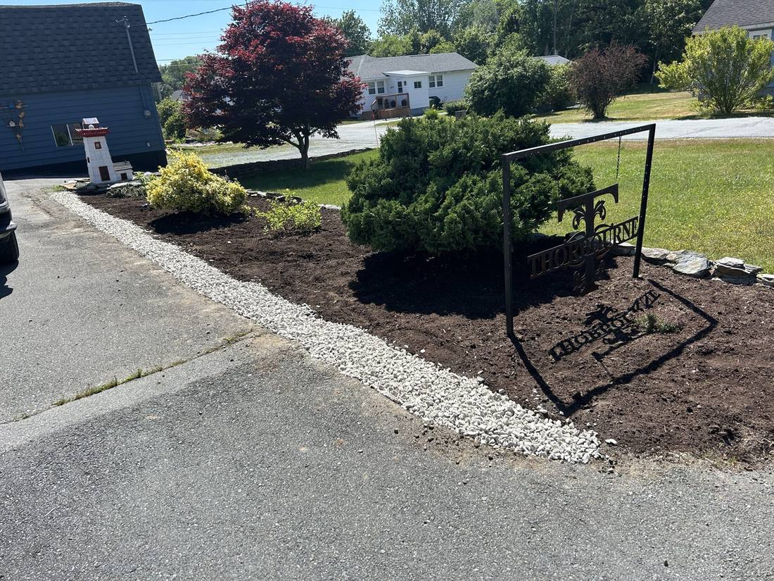 Garden bed after: fresh mulch, clean gravel border, defined edges